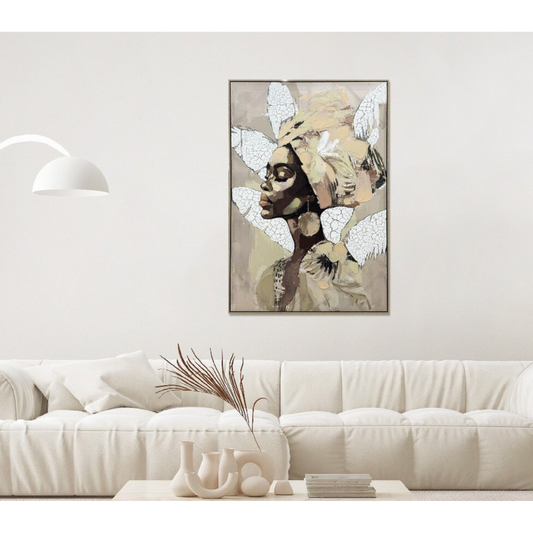 Framed artwork of a stylized portrait on a wall above a white sofa.