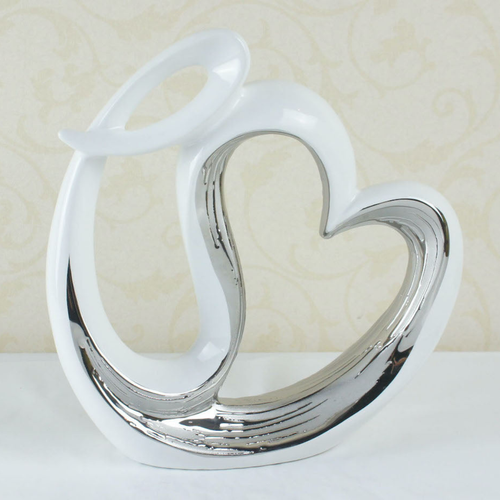 White and silver intertwined hearts ceramic sculpture on a white surface — Mish Lifestyle NZ home décor