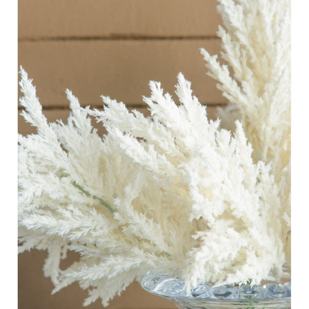Close-up detail of ivory faux pampas grass plume showing soft cloud-like feathery texture in cream and white tones