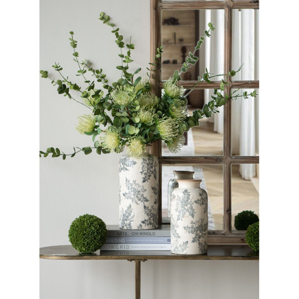 Small Jardin Toile ceramic vase styled on a console table with eucalyptus and protea stems alongside a larger vase and timber window mirror
