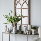 Jardin Toile ceramic vase collection displayed on a console table beneath an arched timber mirror with owl figurines and moss balls