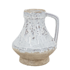 Small ceramic jug with single handle, wide squat body, mottled white-grey speckled glaze on upper half and raw sandy terracotta unglazed base, photographed on white background