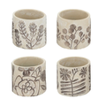Set of four small cream ceramic pots each with a different hand-etched botanical design — fern sprig, eucalyptus branch, poppy with bee, and wildflower with fern — in stone-cream matte ceramic with brown etching, photographed on white background