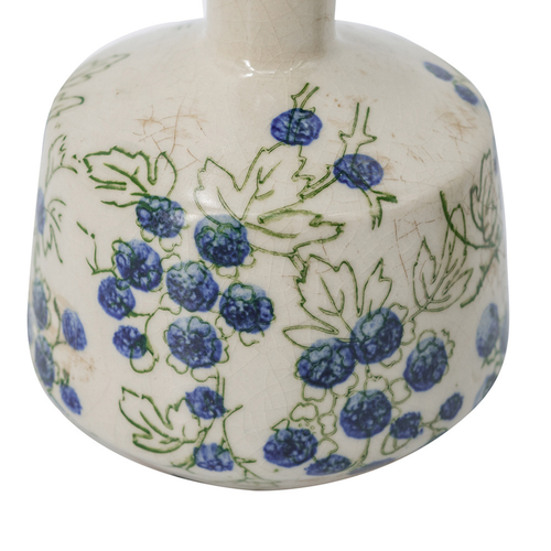 Close-up of rounded ceramic vase with hand-painted blueberry and leaf detail