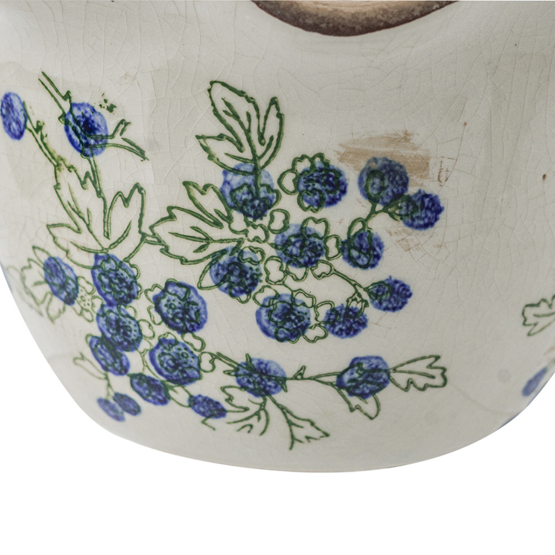 Close-up of blueberry ceramic planter showing hand-painted berry and leaf detail