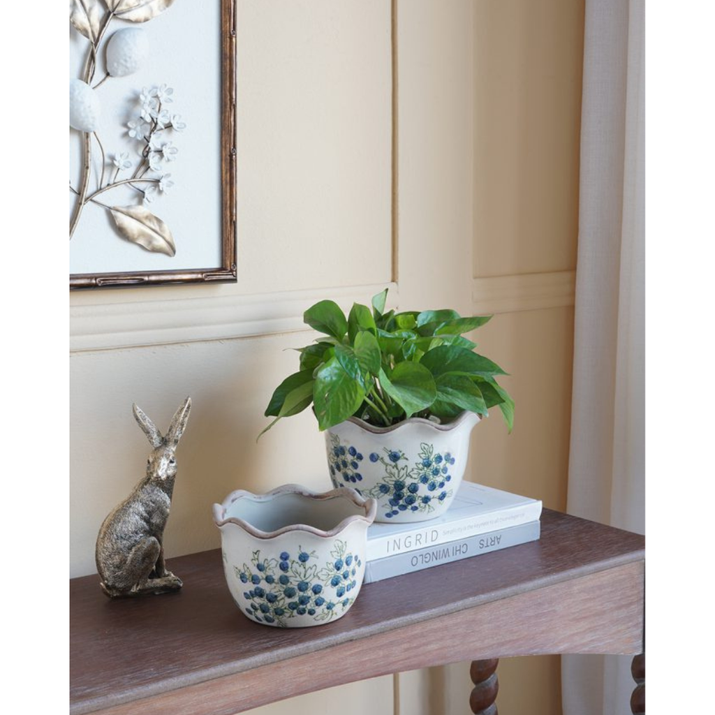 Blueberry ceramic planter with potted plant styled on console table beside bronze rabbit figurine
