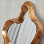 Close-up of brushed gold wavy sculpted frame on asymmetric wall mirror — Mish Lifestyle NZ