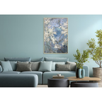 Living room with a blue sofa, decorative pillows, and a framed artwork on the wall.