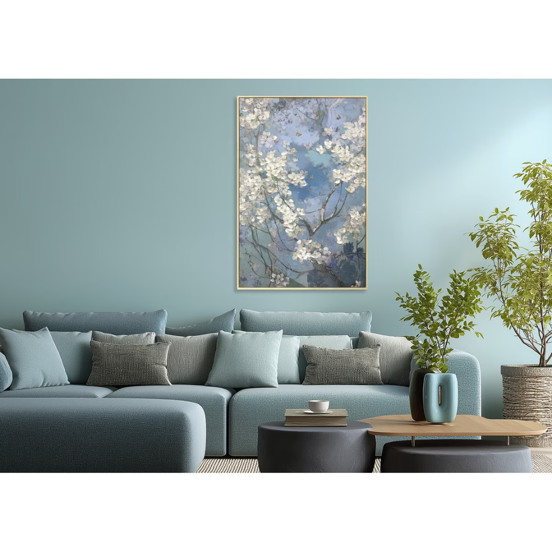 Living room with a blue sofa, decorative pillows, and a framed artwork on the wall.