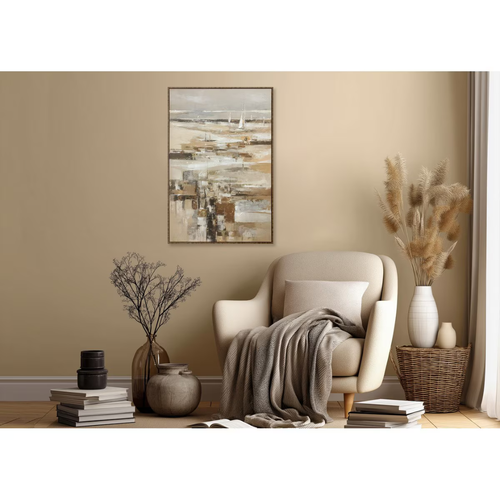 Cozy living room with a beige armchair, decorative plants, and abstract art on the wall. Abstract coastal seascape hand-painted canvas wall art with white sailboats on misty horizon in warm sandy neutrals and gold — framed original artwork in ornate dark bronze and gold frame
