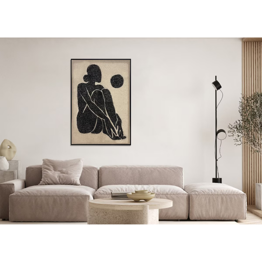 Modern living room with a beige sofa, coffee table, and wall art.